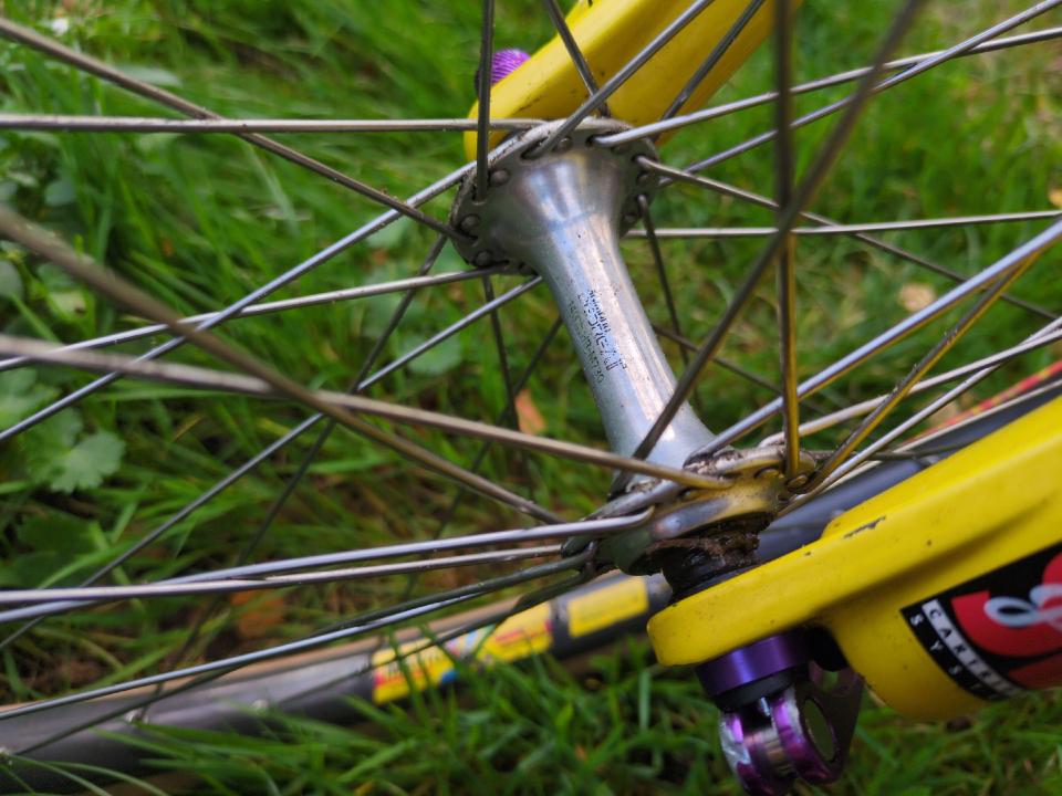 The hubs are silver and predate the chunkier modern designs. Somewhat faded engraving says "SHIMANO DEORE XT".