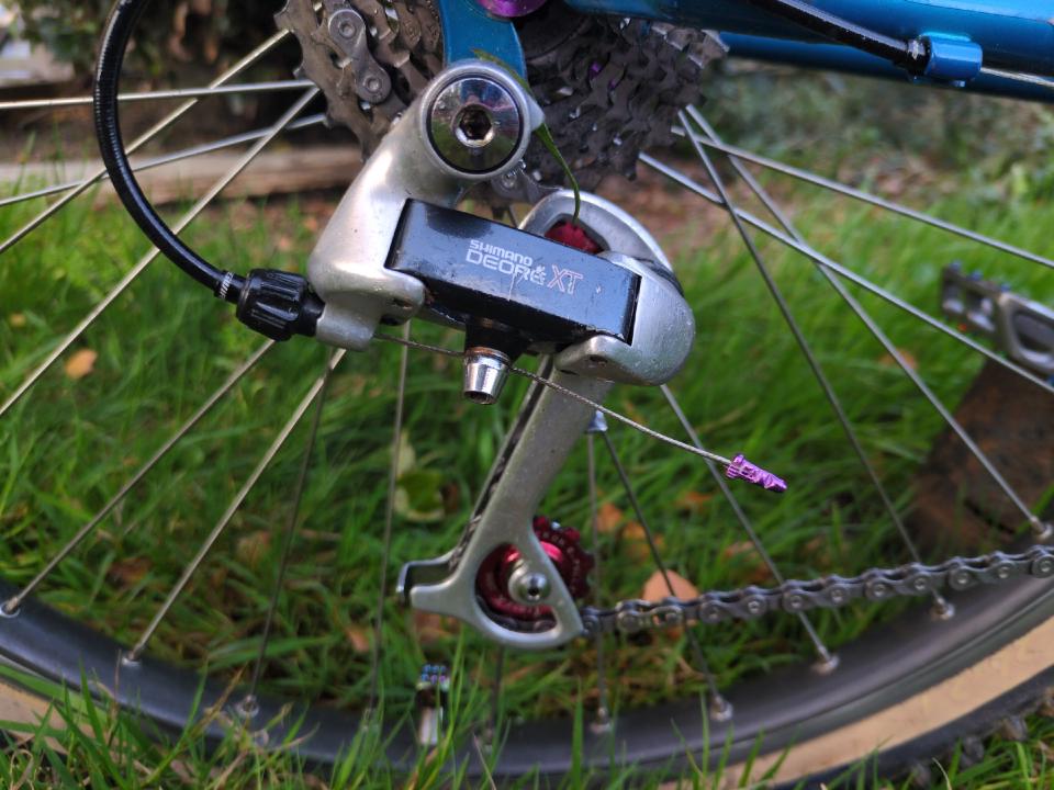 My rear mech; it is early 1990s in styling with red anodised jockey wheels.