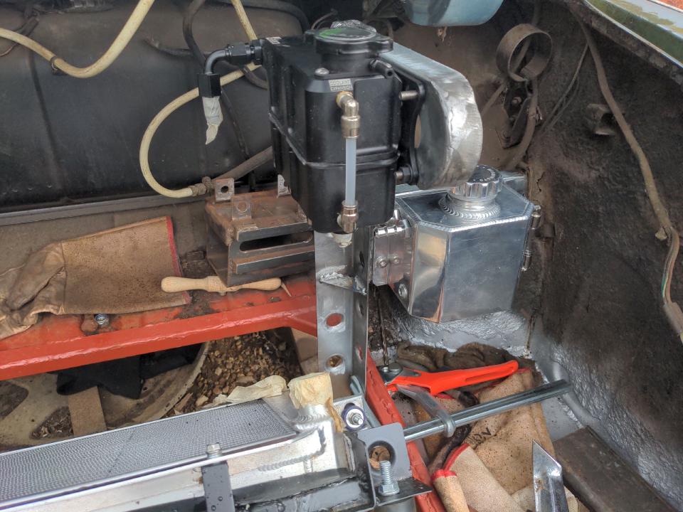 A view into my boot of the dry run of fit-up with the expansion tank and overflow tank.
