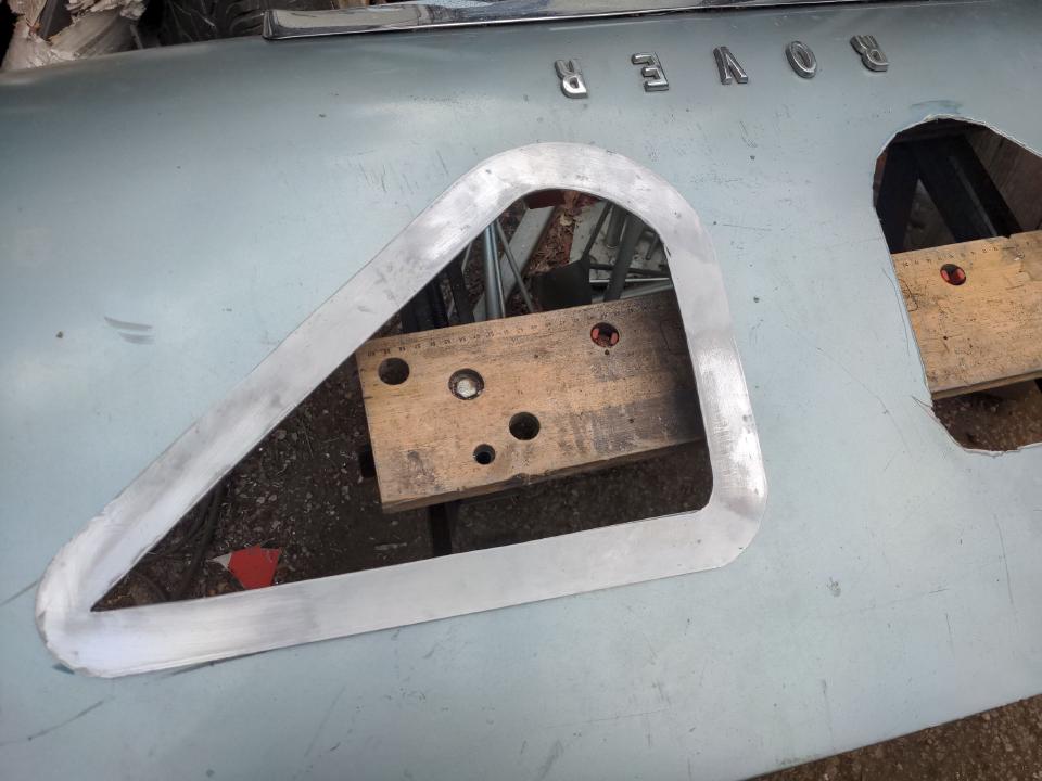 The triangles cut out. It is a right angle triangle with rounded corners, with another right angle triangle cut out from inside it, inset by about an inch.