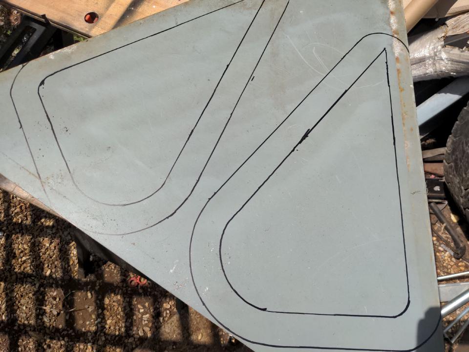 A triangular road sign with the shape of the outside of the vent drawn onto it.