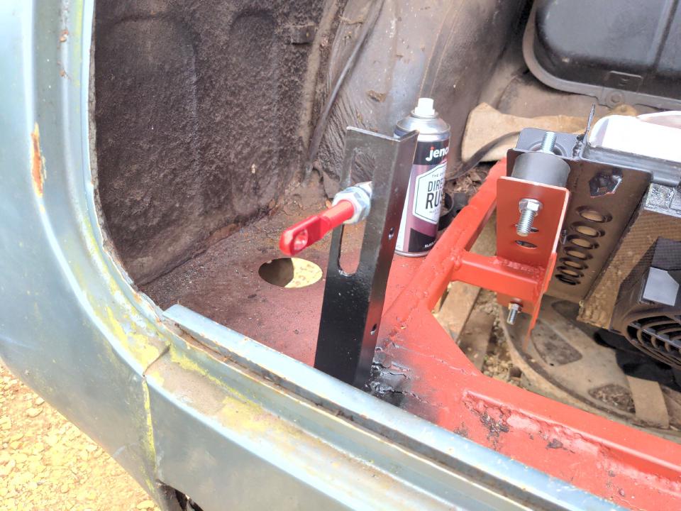 The strike stud mounted on a piece of vertical angle iron, welded to the boot floor of the P5.