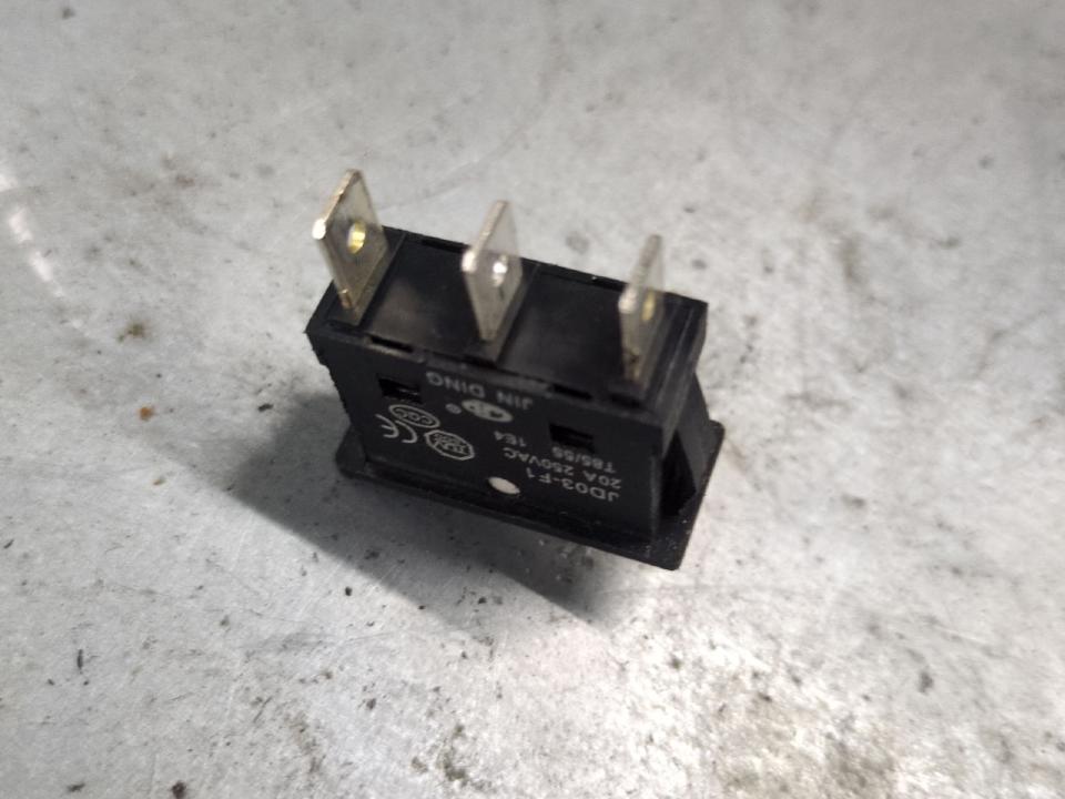 One of the aforementioned power selection switches removed from the welder, and turned upside down. It has three pins on the back.