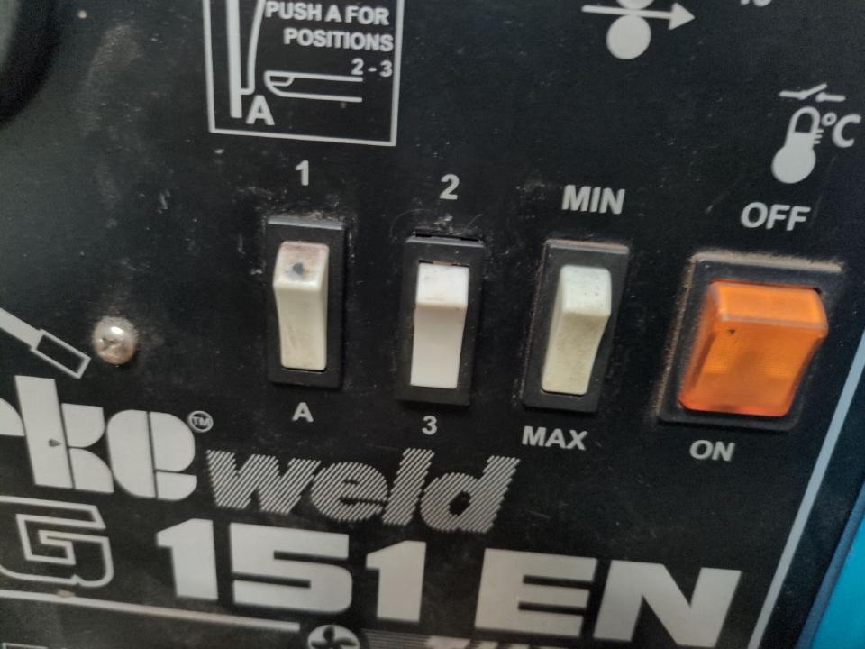 Three white two-position switches on the front of my Clarke 151 EN welder. The left is marked 1/A, middle is 2/3, right is MIN/MAX.