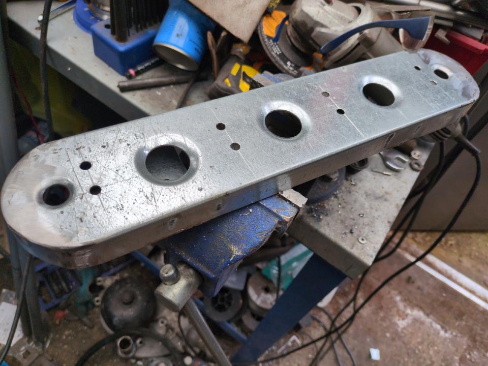 As the previous picture, but with four large holes added and dimpled to add strength and to look cool.