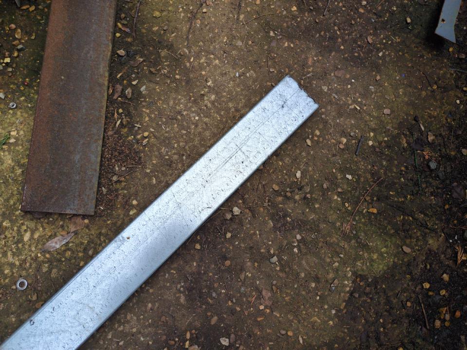 A piece of galvanised C-section steel about 2 inches wide and six feet long.