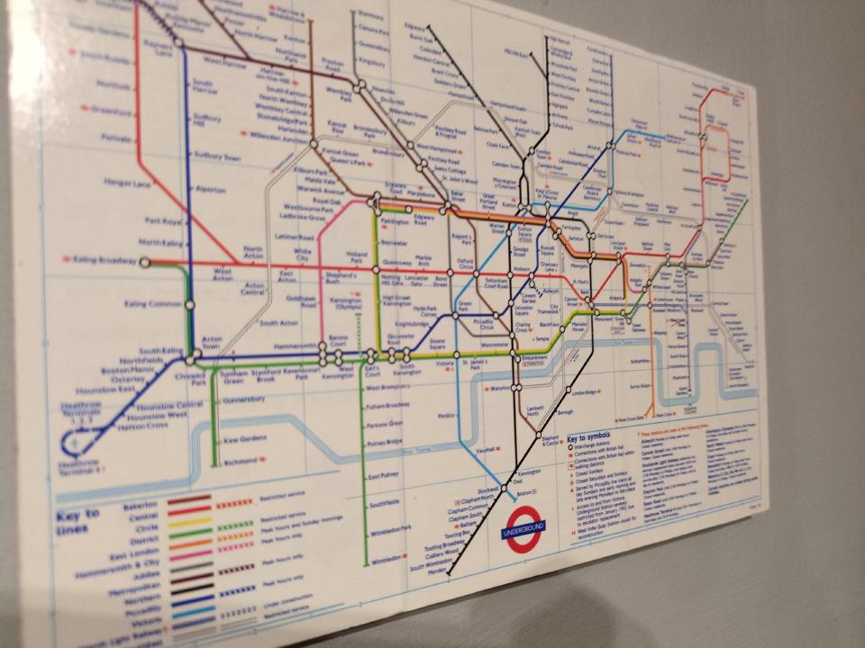 A London Underground map, about A4 size, mounted on a foam board and with a shiny finish.