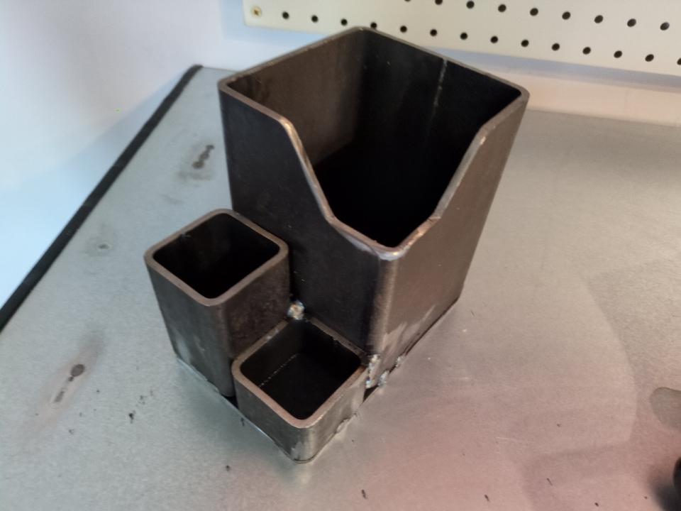 My over-engineered pen pot. It is made of a piece of 100mm box section about 5 inches high, welded to a piece of 50mm box section about 3 inches high, and another piece of the 50mm box section about 1.5 inches high.