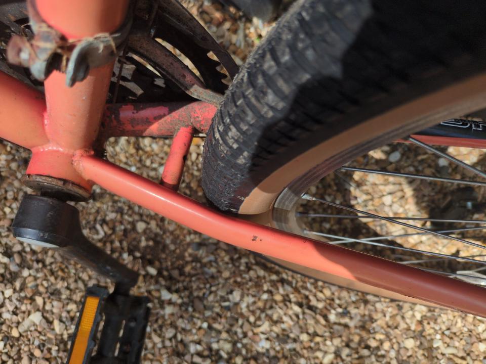 A close-up of a tyre rubbing against a chainstay.
