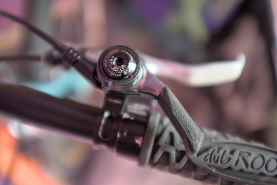 A Microshift SL-T10B thumb shifter mounted on my handlebars.