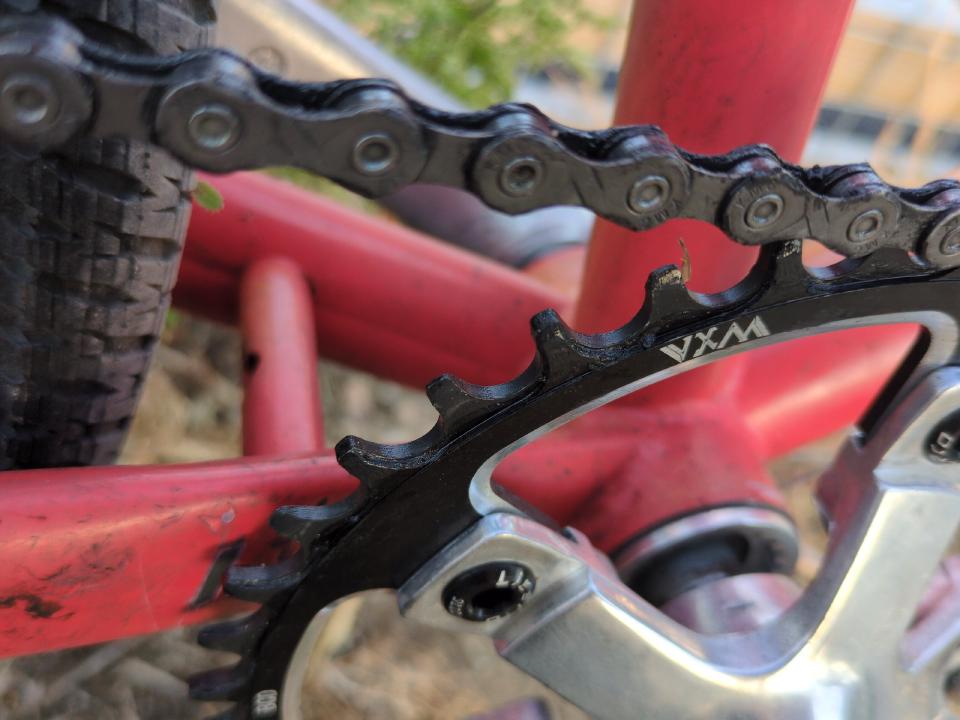 A close-up of a narrow-wide chainring, showing the alternating wide and narrow teeth.
